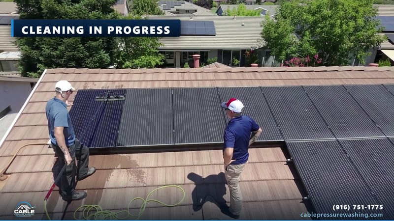 Cable Pressure Washing crew cleaning rooftop solar panels with water-fed poles